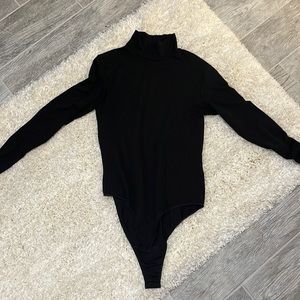 The top is Uniqlo it’s a black bodysuit very thin mid neck